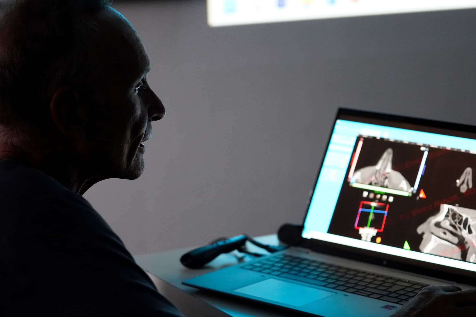 Dr Enrico Robotti in his office, sitting at his computer